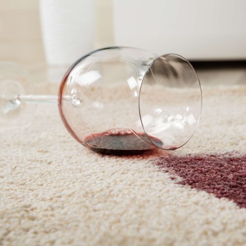 Red Wine Spilled From Glass On Carpet High Angle View Of Red Wine Spilled From Glass On Carpet